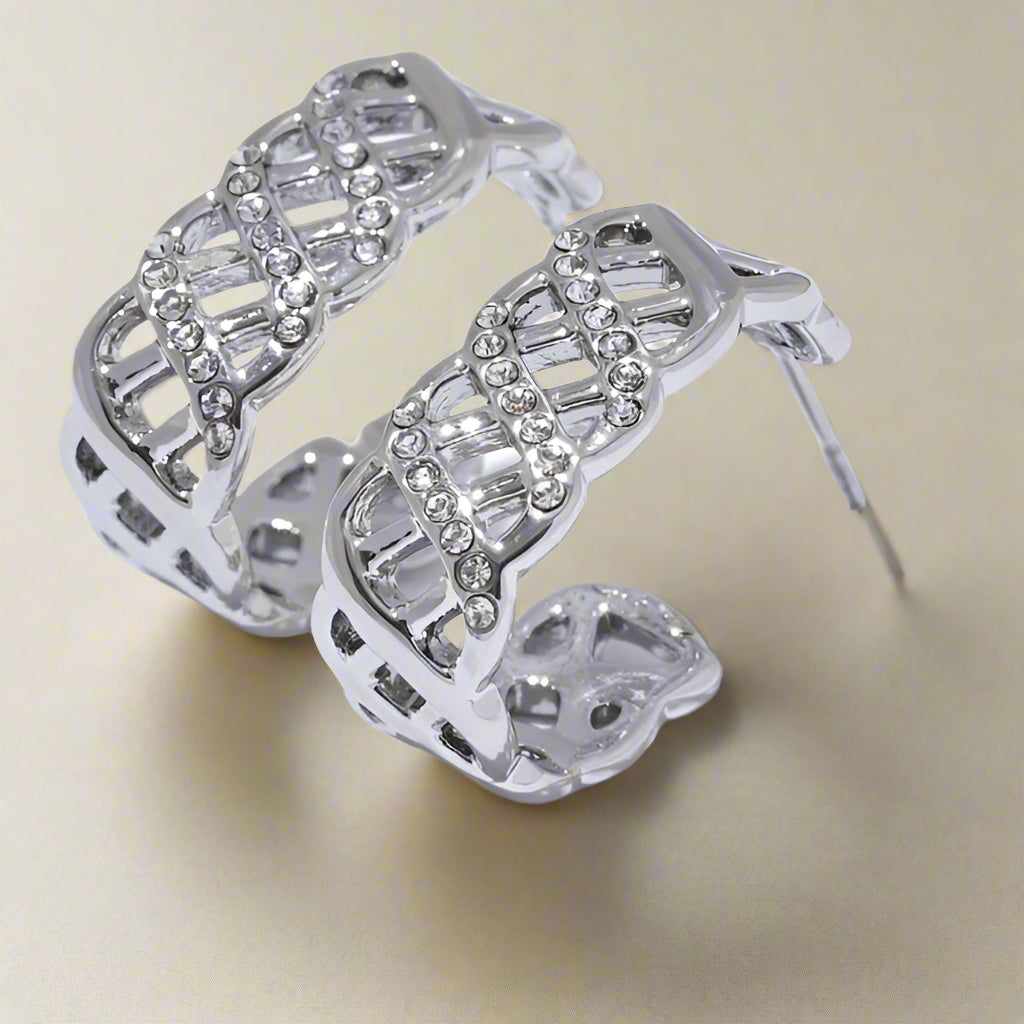 Silver hoop earrings with intricate design on a white background