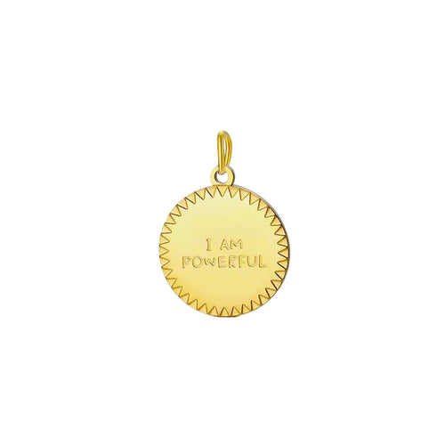 Gold pendant with 'I AM POWERFUL' engraving on a light gray background