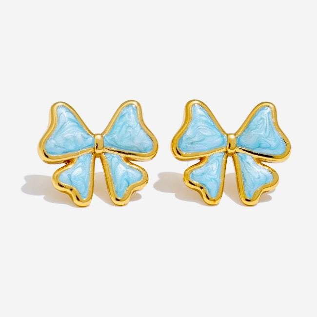 Pair of light blue bow-shaped earrings with gold accents on a white background