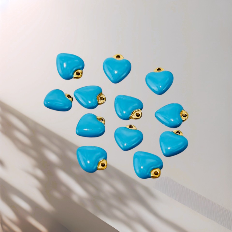 Blue heart-shaped charms with gold loops on a white background