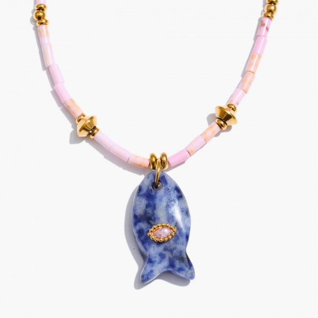 Necklace with a blue fish pendant on a pink beaded chain against a white background