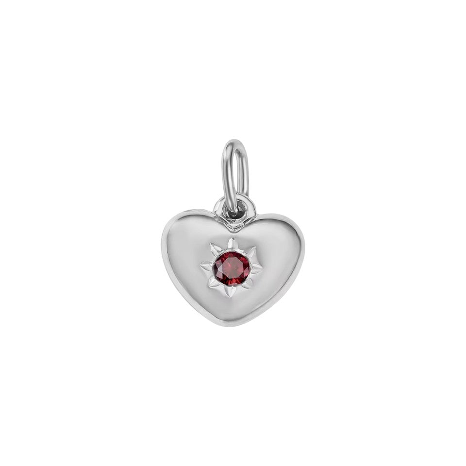 Silver heart-shaped charm with a red gemstone on a white background