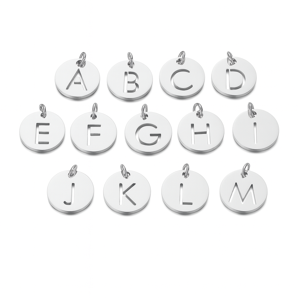 Set of silver letter charms from A to M on a white background