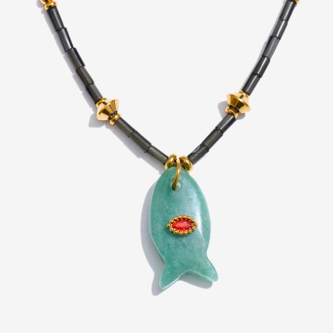 Necklace with a green fish-shaped pendant on a white background