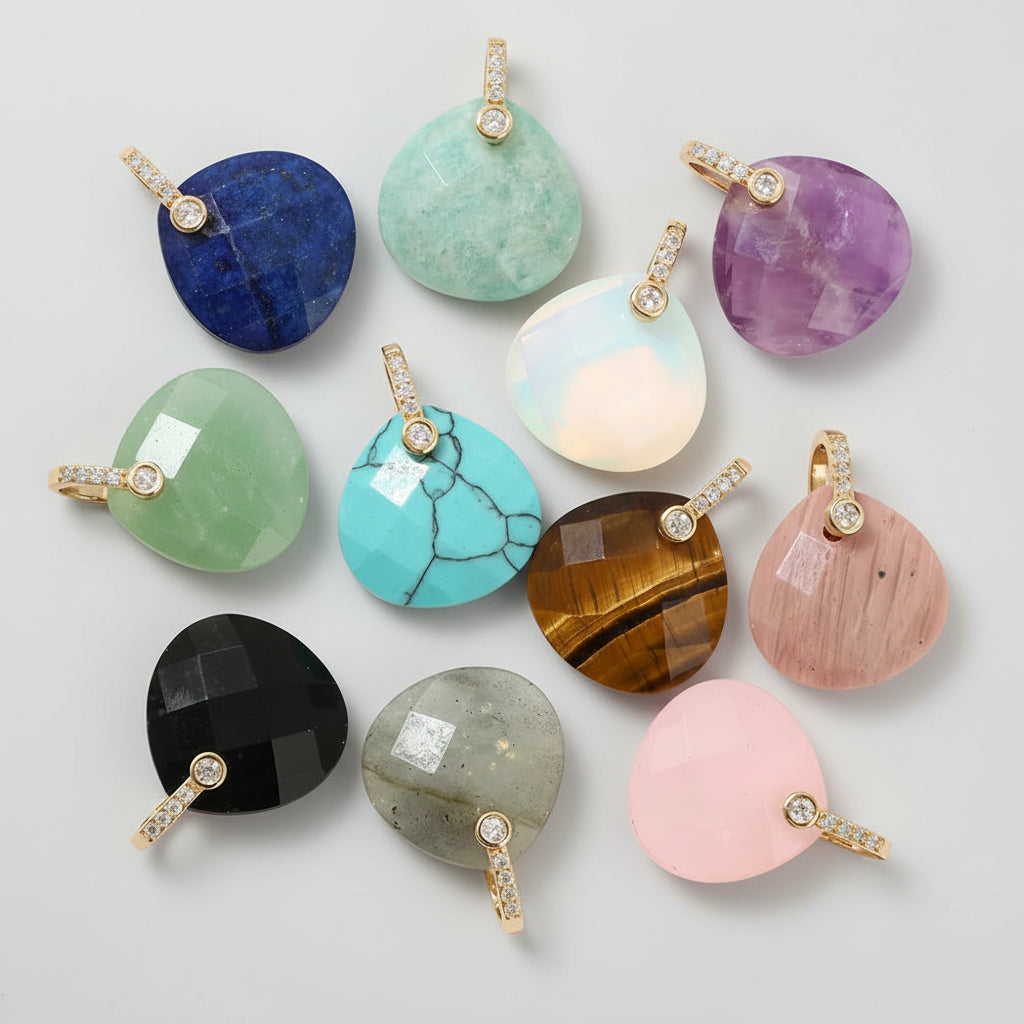 Collection of various gemstone pendants on a white background