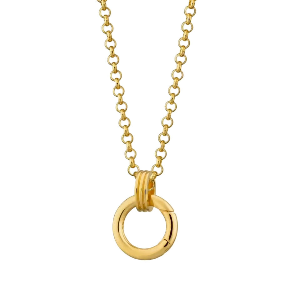 Gold necklace with a unique ring pendant on a beige background
