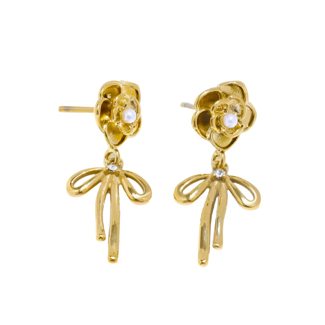 Gold floral earrings with dangling leaves on a white background
