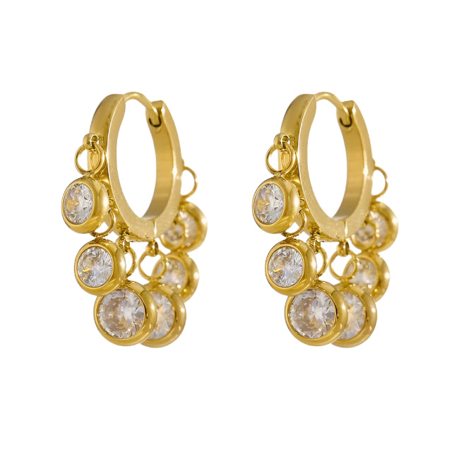 A pair of gold-plated hoop earrings with dangling clear crystals, presented against a white background.