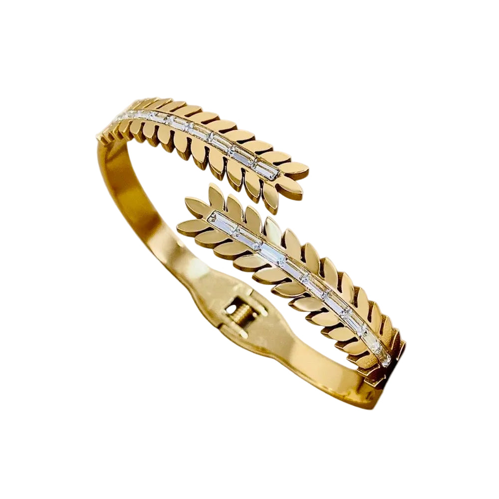 Gold bracelet with leaf design on a white background