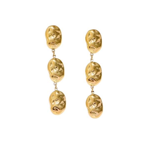 Pair of gold earrings with face-like designs on a white background