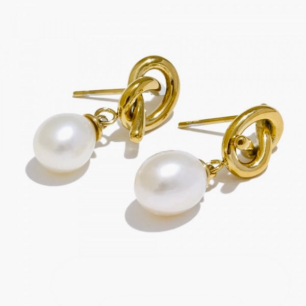 A pair of drop earrings featuring genuine freshwater pearls suspended from a polished knot detail, with 316 stainless steel/18k Gold PVD plating.