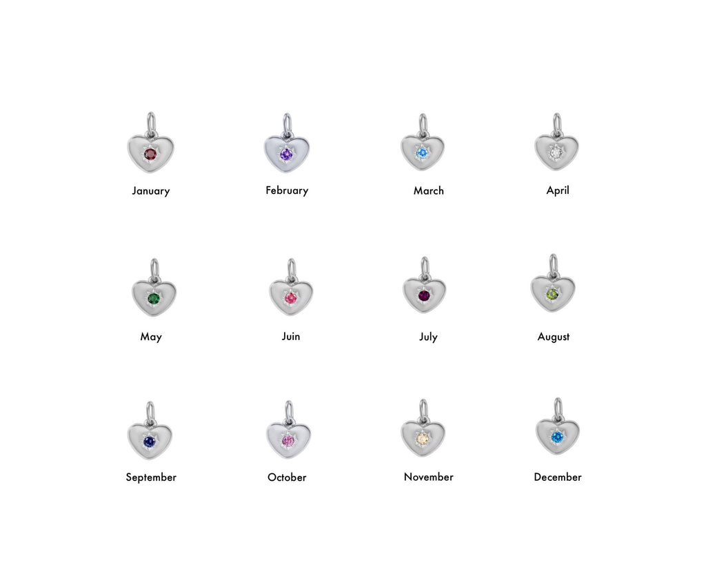 Heart-shaped charms with colored stones for each month on a white background