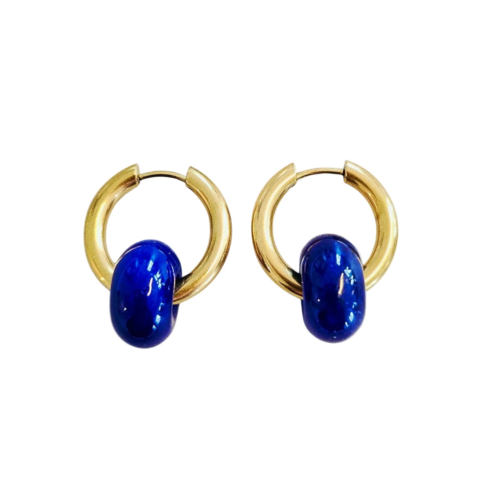 Gold hoop earrings with blue stones on a white background
