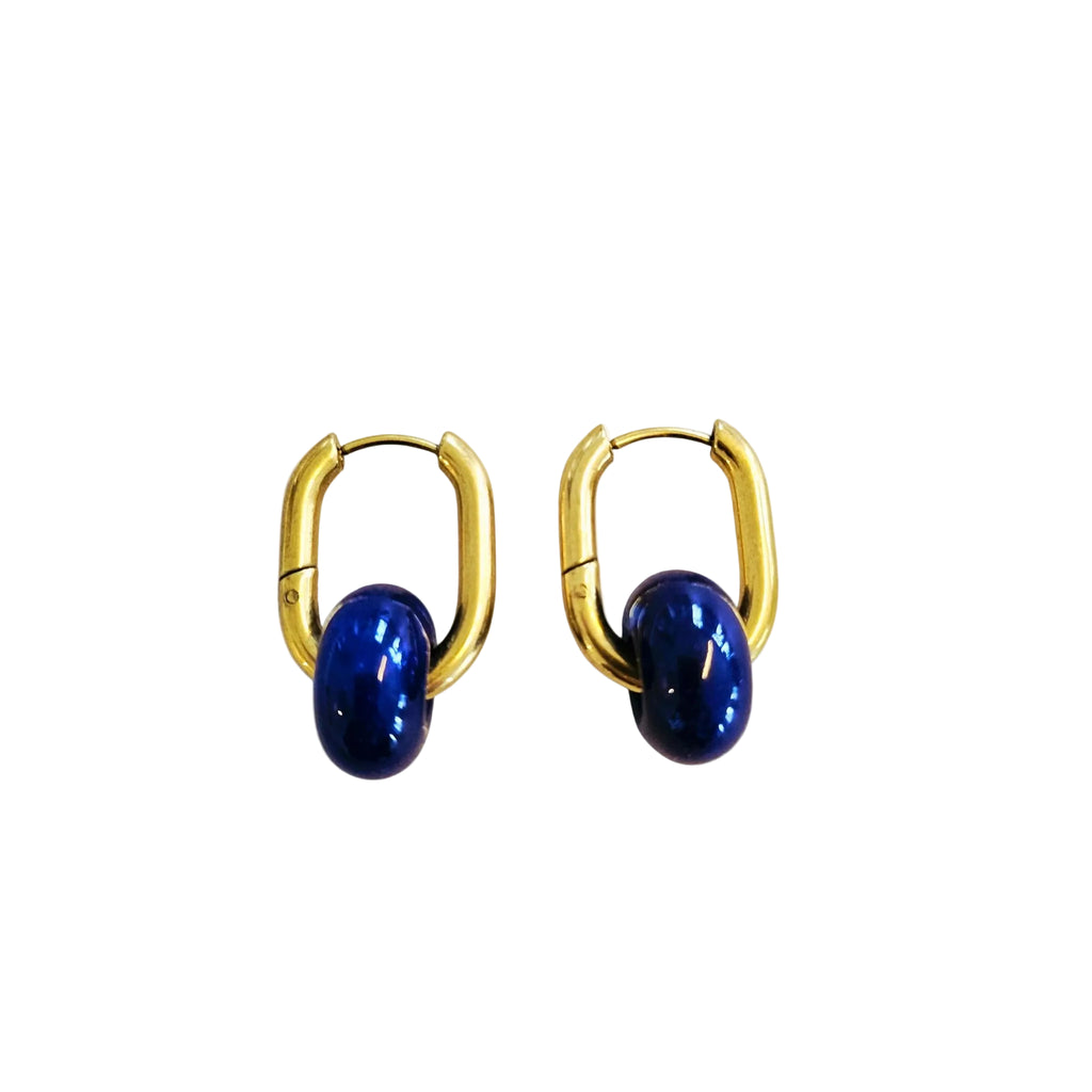 Gold hoop earrings with blue stones on a white background