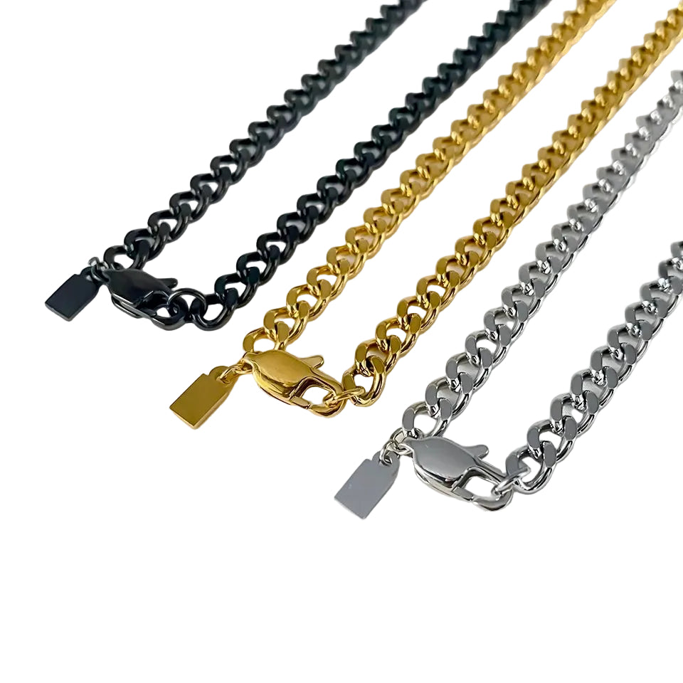 Three chain necklaces in black, gold, and silver on a light gray background