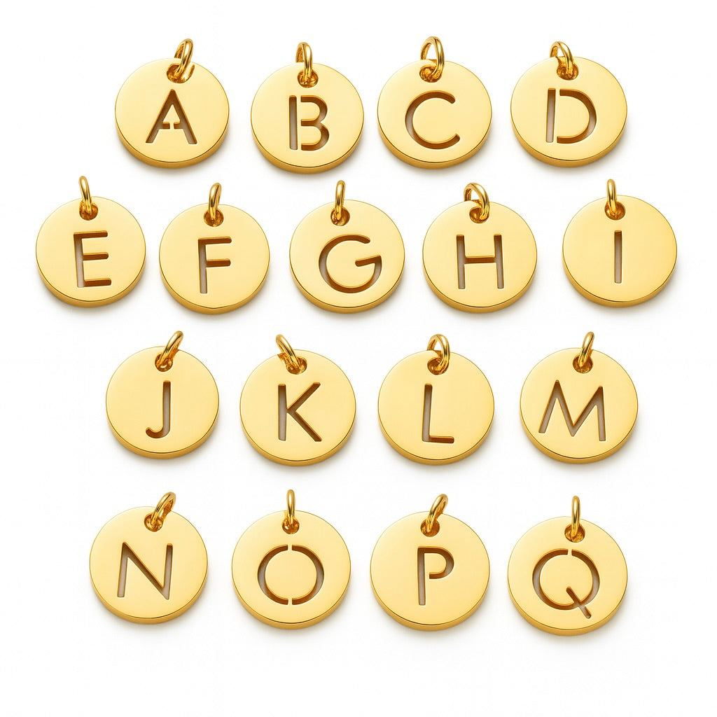 Gold letter charms from A to Q on a white background