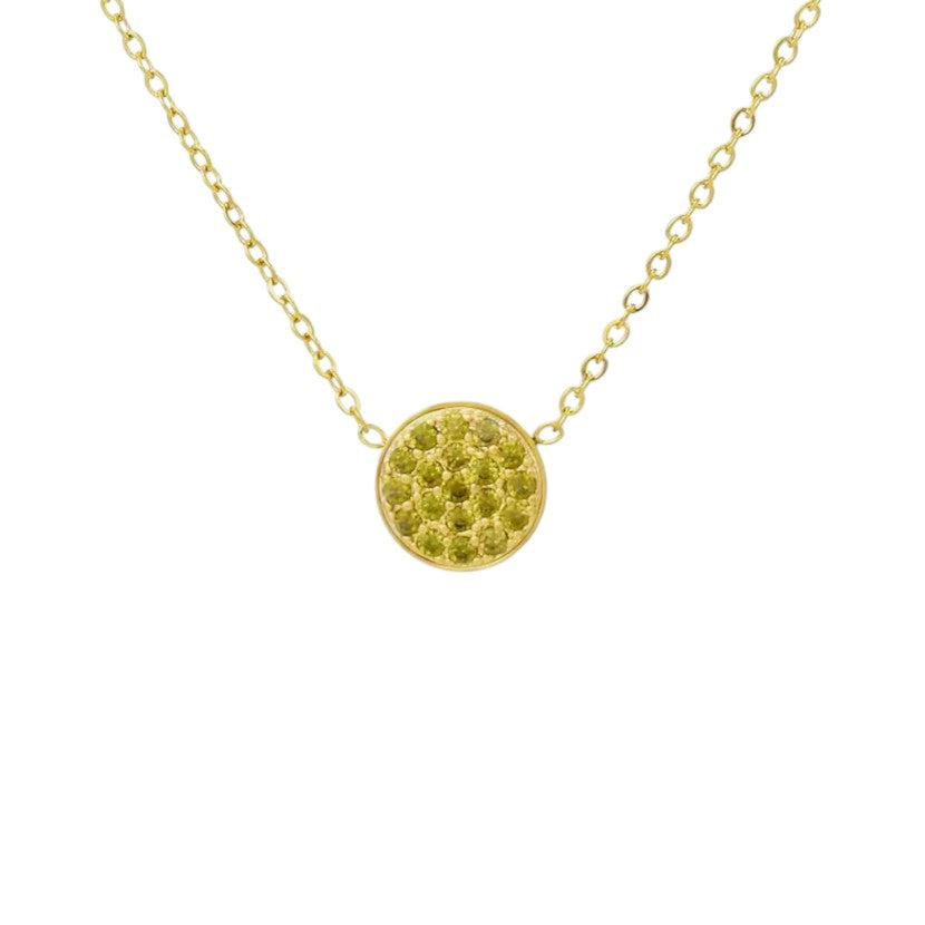 Gold necklace with a round, textured pendant on a white background
