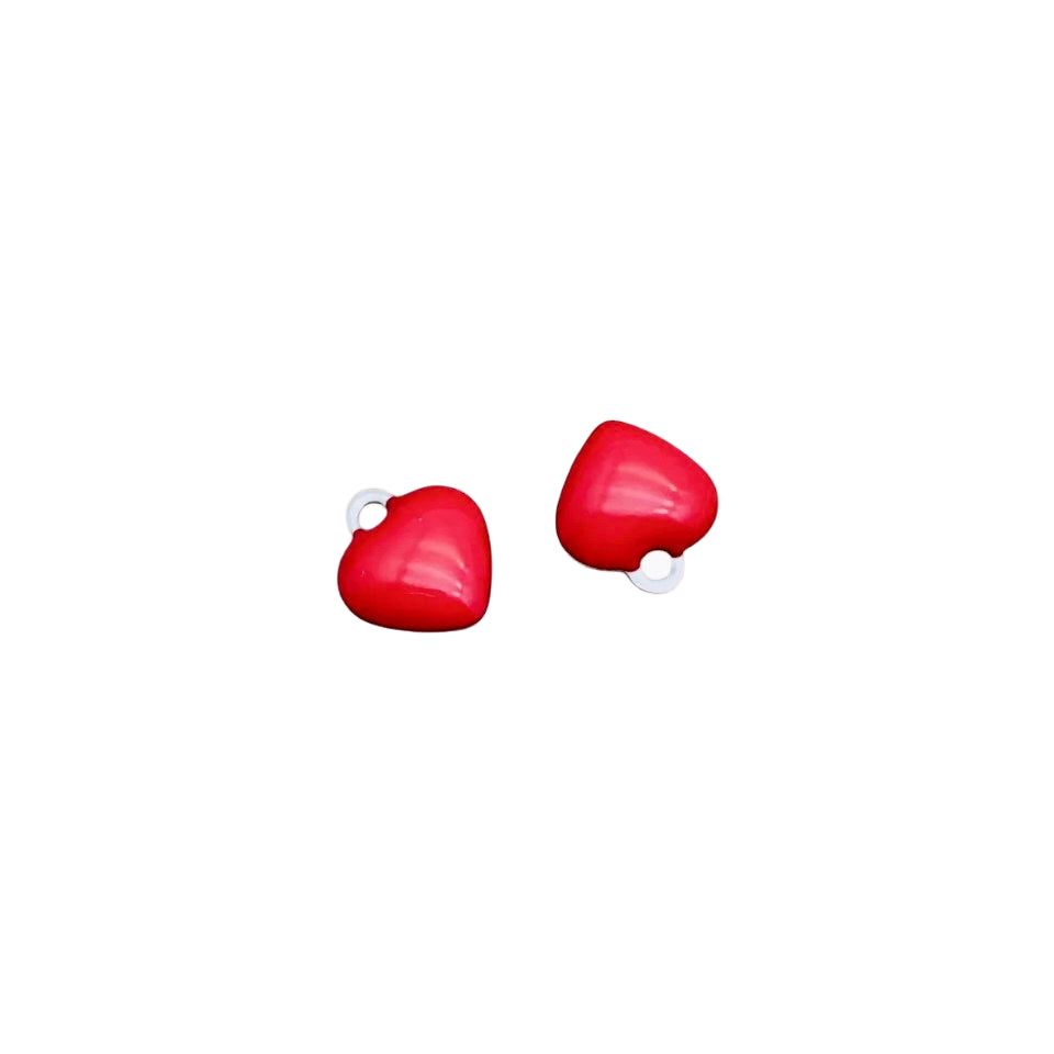 Red heart-shaped earrings on a white background