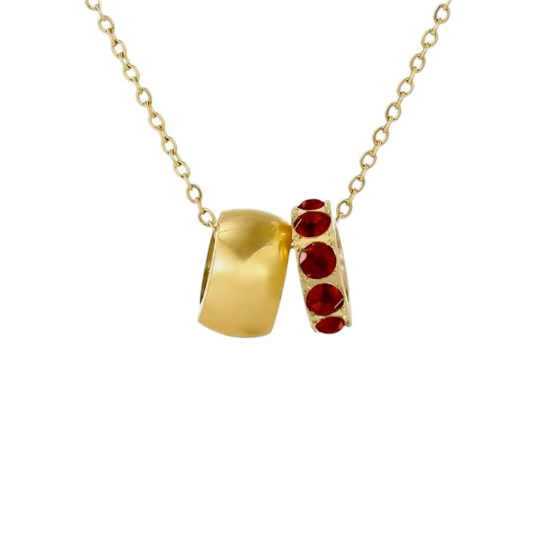 Gold necklace with red gemstones on a white background