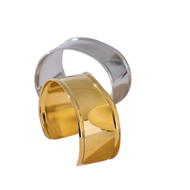 Gold and silver cuff bracelets on a white background