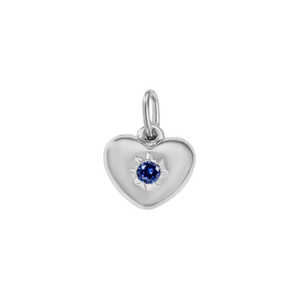 Silver heart-shaped pendant with a blue gemstone on a white background