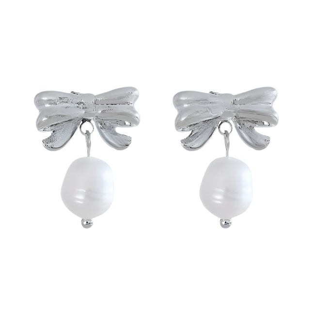 Silver bow-shaped earrings with pearl drops on a white background