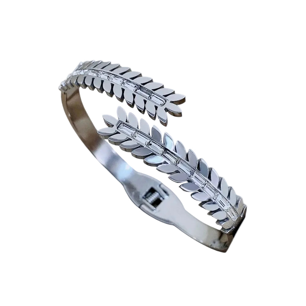 Silver bracelet with leaf design on a white background