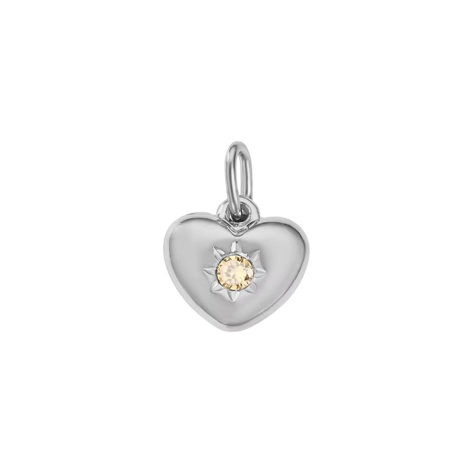 Silver heart-shaped pendant with a yellow gemstone on a white background