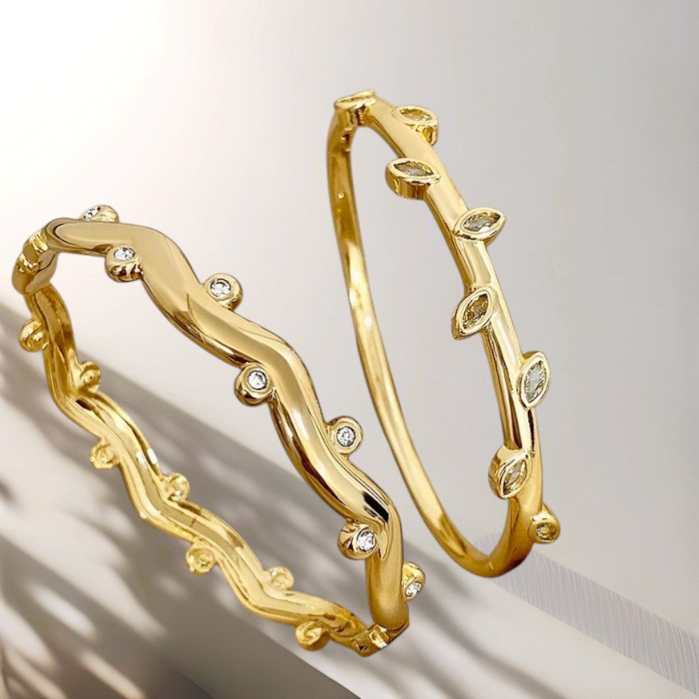 Gold hoop earrings with diamond accents on a neutral background