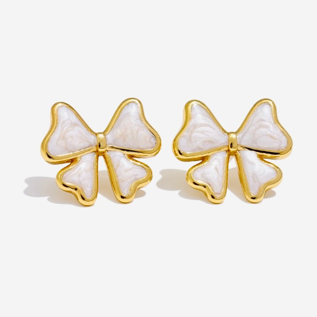 White Bow-shaped earrings with gold outline on a white background
