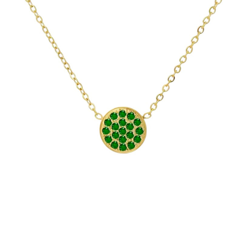Gold necklace with a green gemstone pendant on a white background
