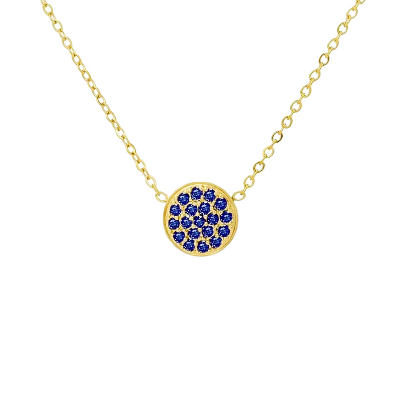 Gold necklace with a blue gemstone pendant on a white background